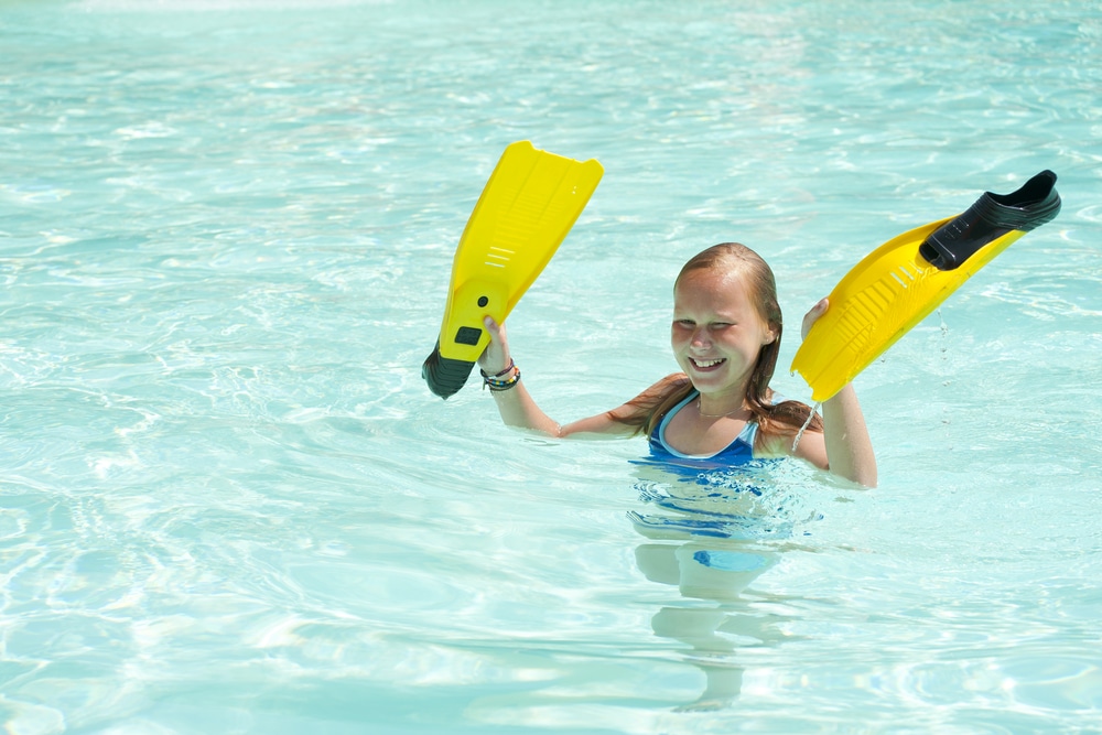 Happy Girl With Flippers In Swimming Pool