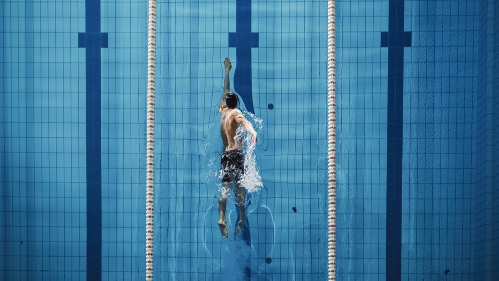 Aerial Top View Male Swimmer Swimming in Swimming Pool, Freestyle swimming