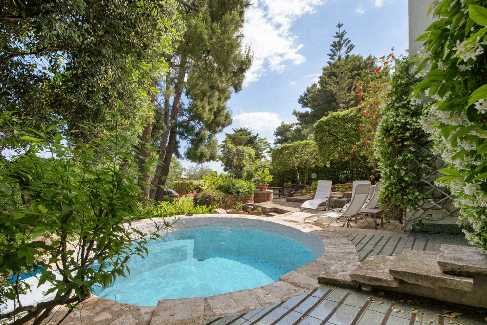 Small pool full with clear blue water in the backyard of beautiful villa close to the sea