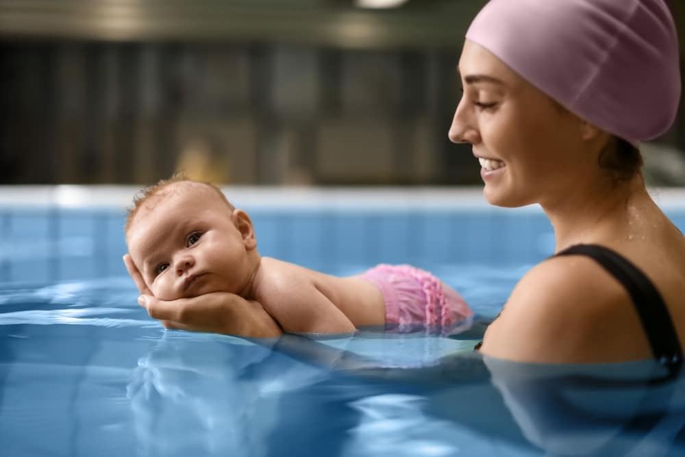 Cute Baby With female instructor In Swimming Pool