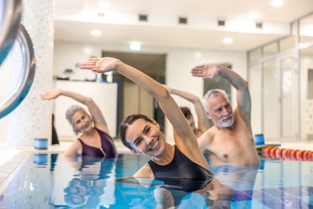 Senior Adults In The Swimming Pool During Aqua Aerobics Class