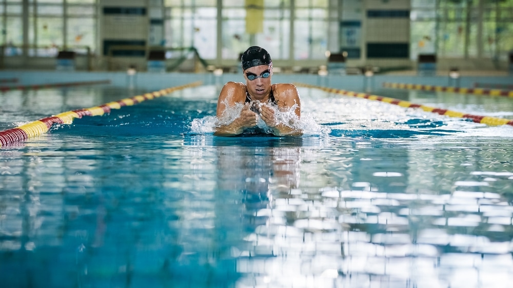 Sportswoman A Professional Swimmer Using Breaststroke Drills During A Swim