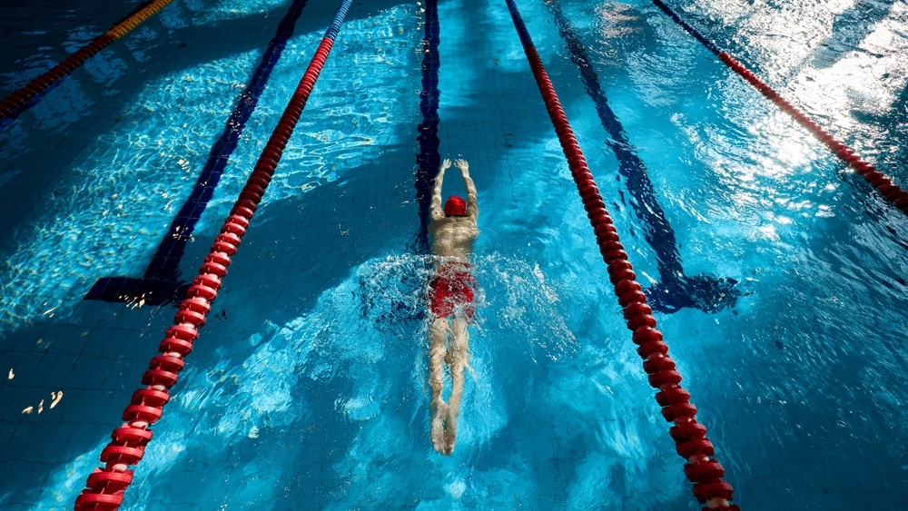 Top View Of Muscular Athletic Young Man Swimmer In Red