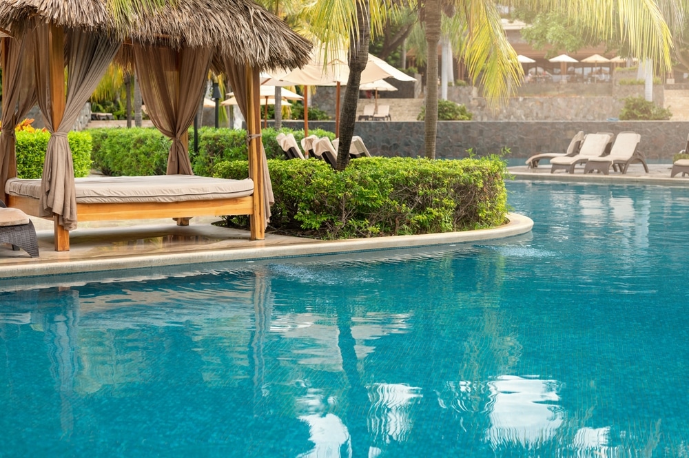 Spa Cabana Next To Blue Pool Outside Of Luxury Hotel