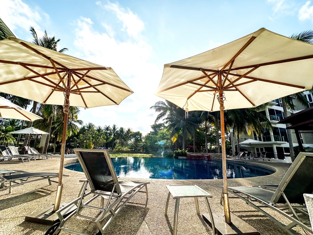 Sun loungers with sun umbrellas in the pool at the sea 