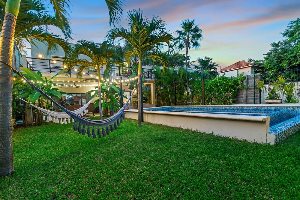 Tropical Villa With Pool Hammocks And Lush Greenery