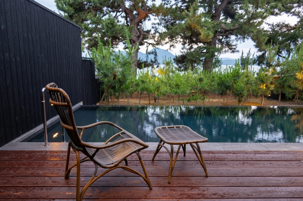 Garden Chair And Ottomans At Poolside Tarrace