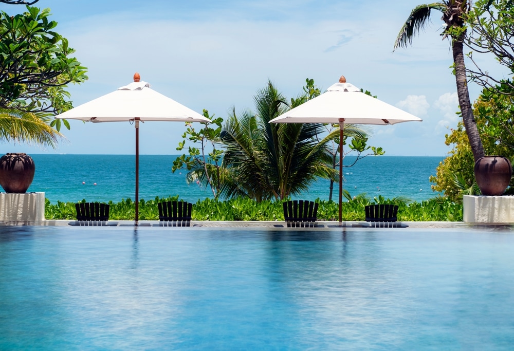 2 umbrellas on pool