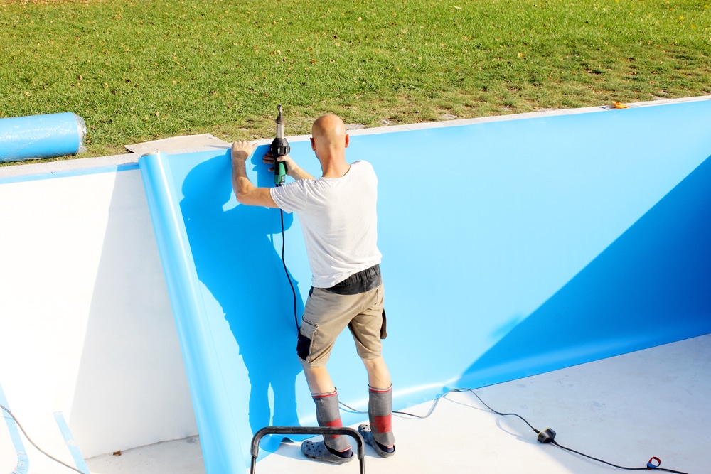 A Worker Welds Plastic Cover For Water Pool Water Pool