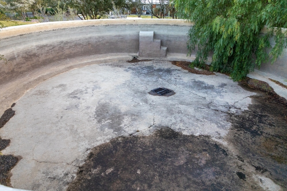 Part Of An Empty Large Round Concrete Pool At The